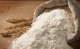 How is flour made from whole grain wheat and where is it used?