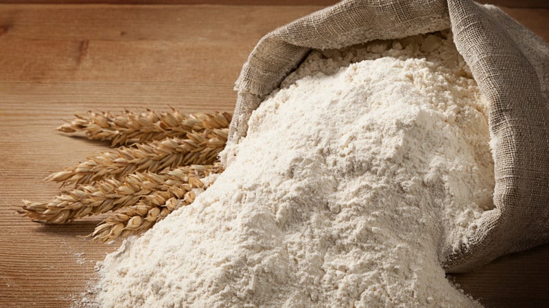 How is flour made from whole grain wheat and where is it used?