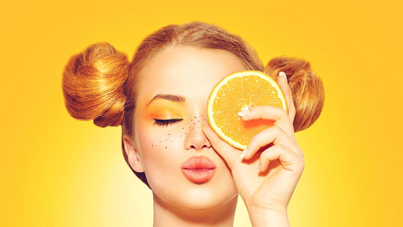 Woman and oranges - benefits and harms