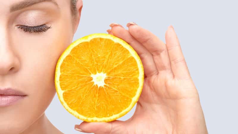 Woman and oranges - benefits and harms
