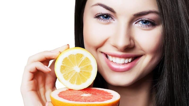 Woman and oranges - benefits and harms