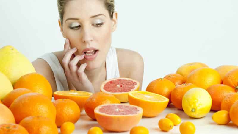 Woman and oranges - benefits and harms