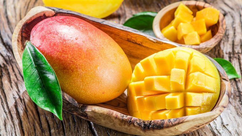 What is the calorie content of mango and what are its benefits and harms?